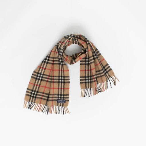 A beige plaid Burberry brand scarf with fringed ends is laid out against a plain white background