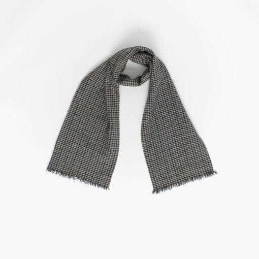 A grey scarf with short fringed ends is laid out against a plain white background