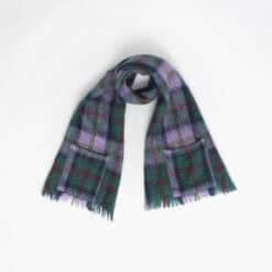 A plaid scarf with fringed ends is laid out against a plain white background.