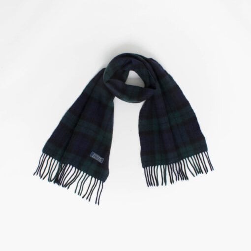 A plaid scarf with fringed ends is laid out against a plain white background.