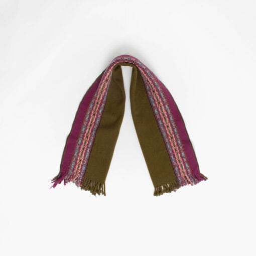 A thick olive green and pink scarf with fringed ends is laid out against a plain white background.