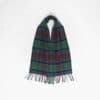 A tartan scarf with fringed ends and button front is laid out against a plain white background.